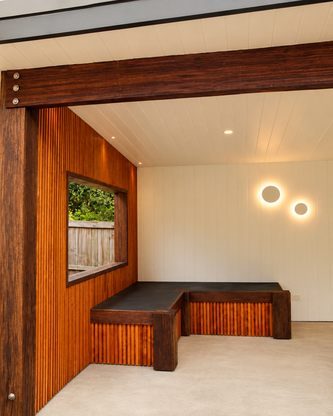 Timber batten nook with built-in bench seating and warm wall lighting